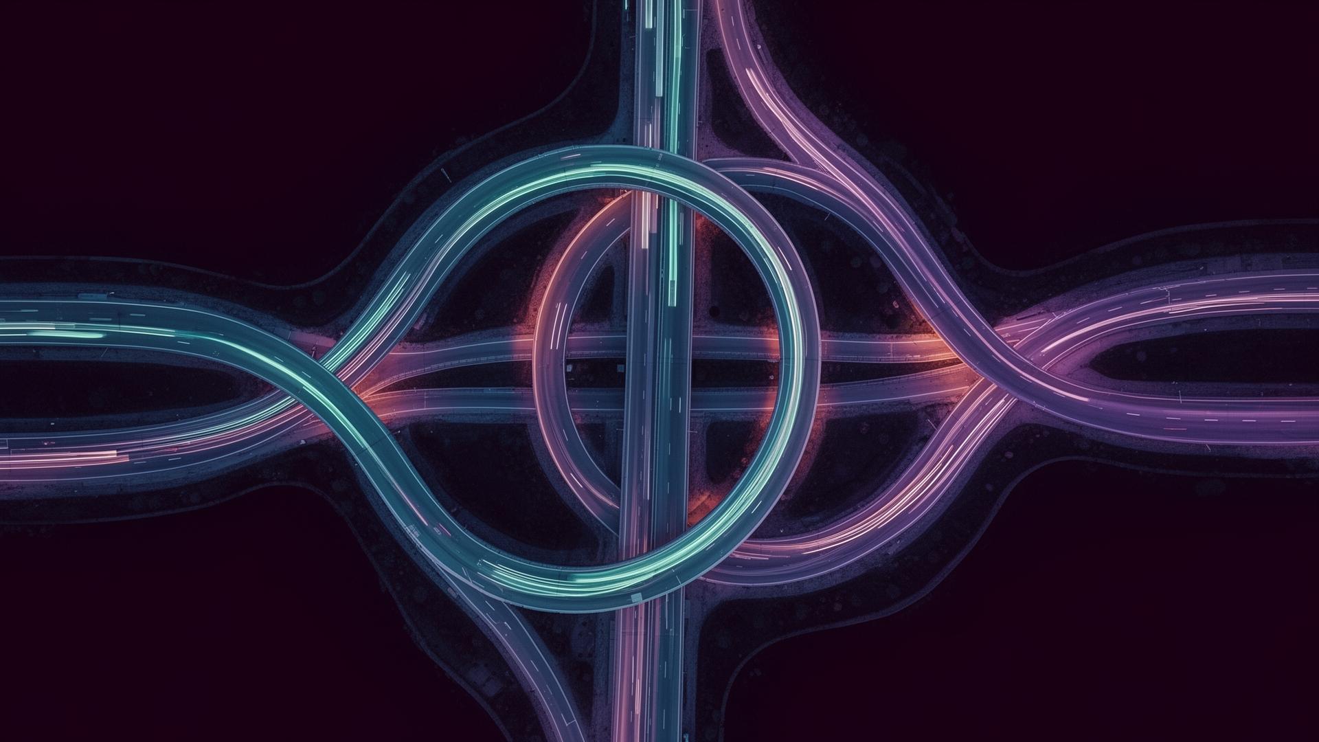 Aerial view of an illuminated multi-level highway interchange at night
